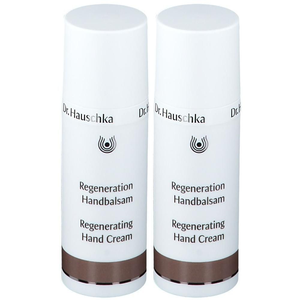 Zwei weiße Flaschen Dr. Hauschka Regeneration Handbalsam mit braunem Band.