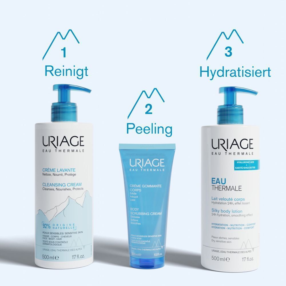 Drei Uriage Produkte: Reinigende Creme, Peeling Creme, Körpermilch. Alle mit blauem Verschluss und Produktnamen.