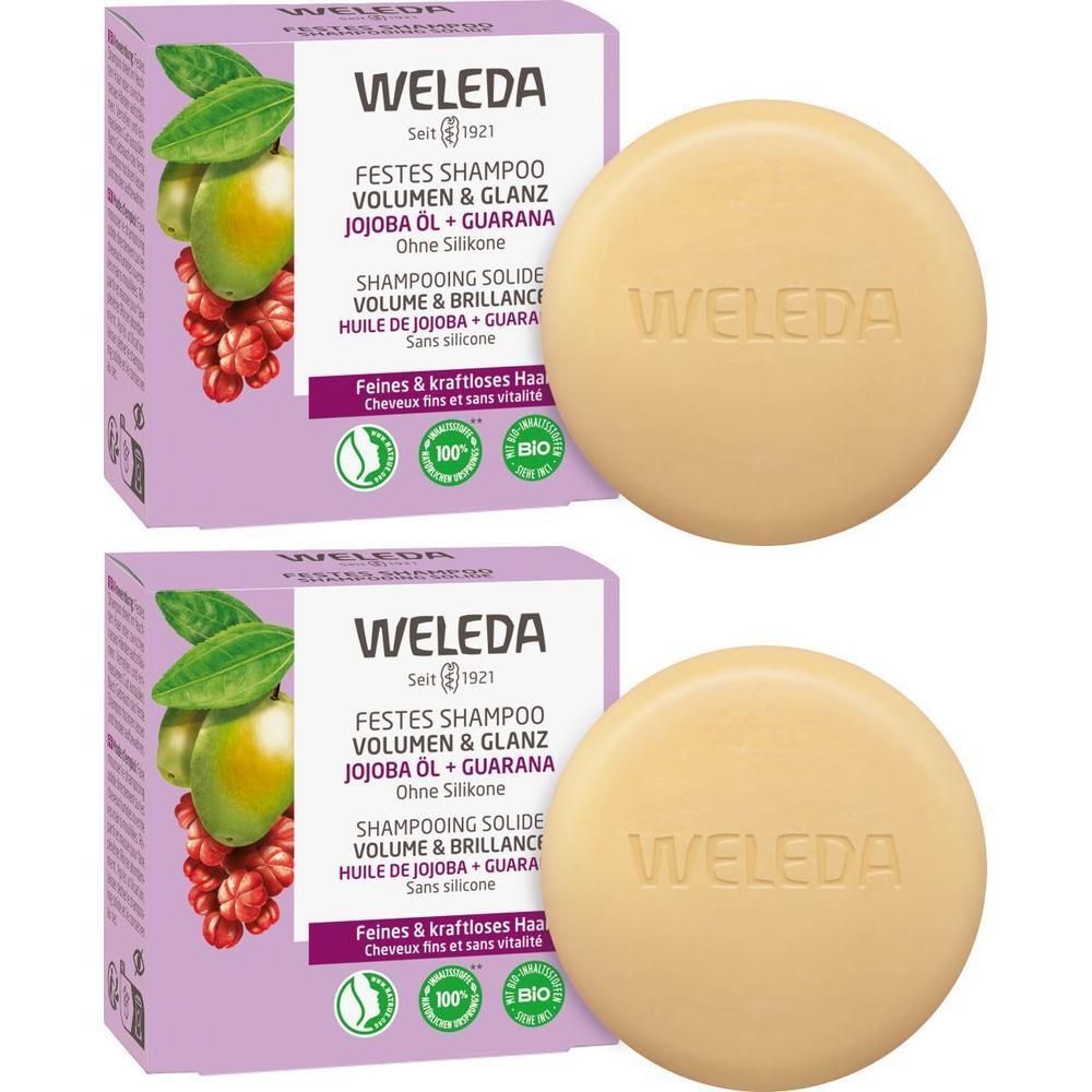 Zwei Packungen WELEDA festes Shampoo. Runde Shampoo-Stücke und Kartonverpackung mit Produktinformationen und Logo.