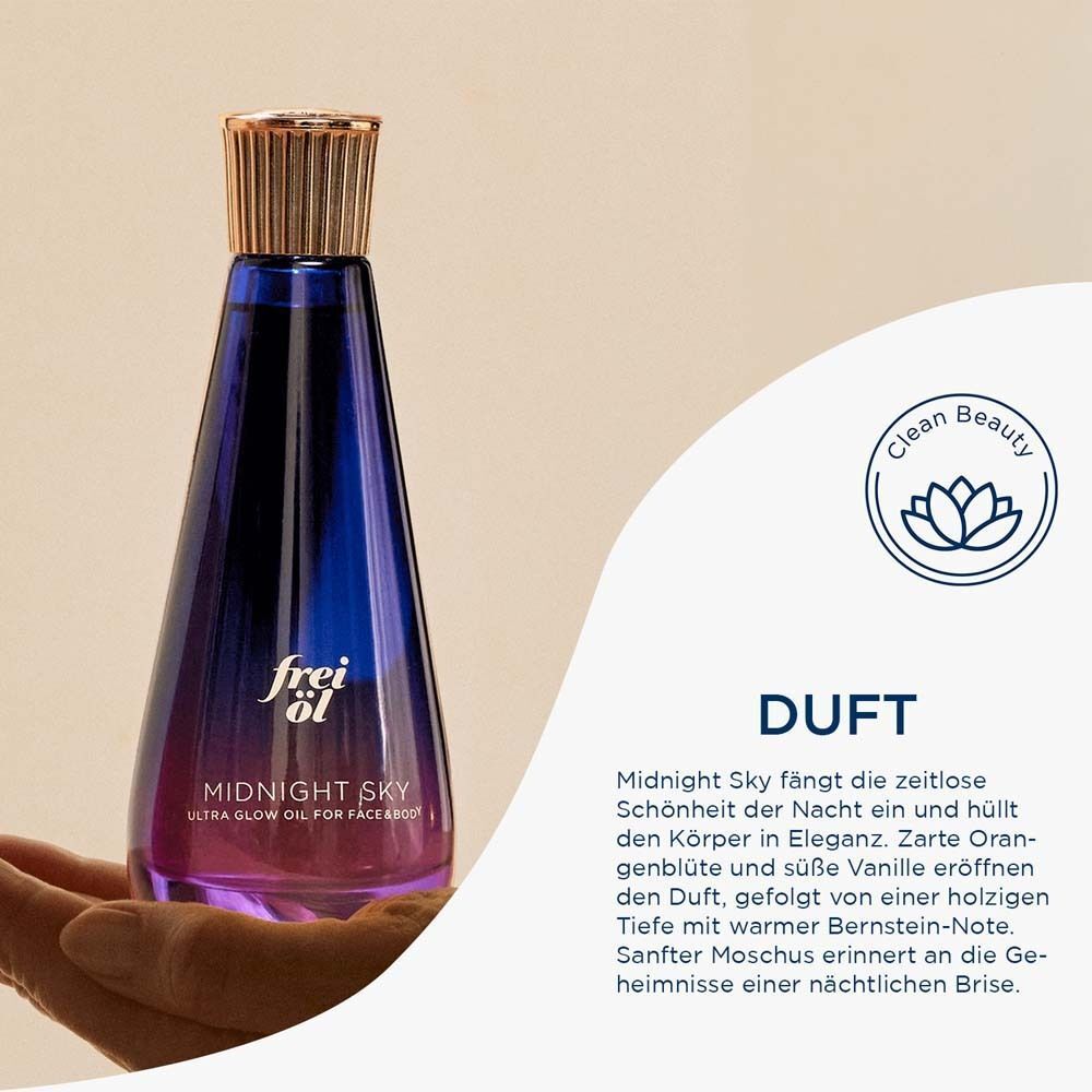 Eine Hand hält eine blaue Flasche mit goldenem Verschluss. Auf der Flasche steht "frei öl" und "MIDNIGHT SKY".