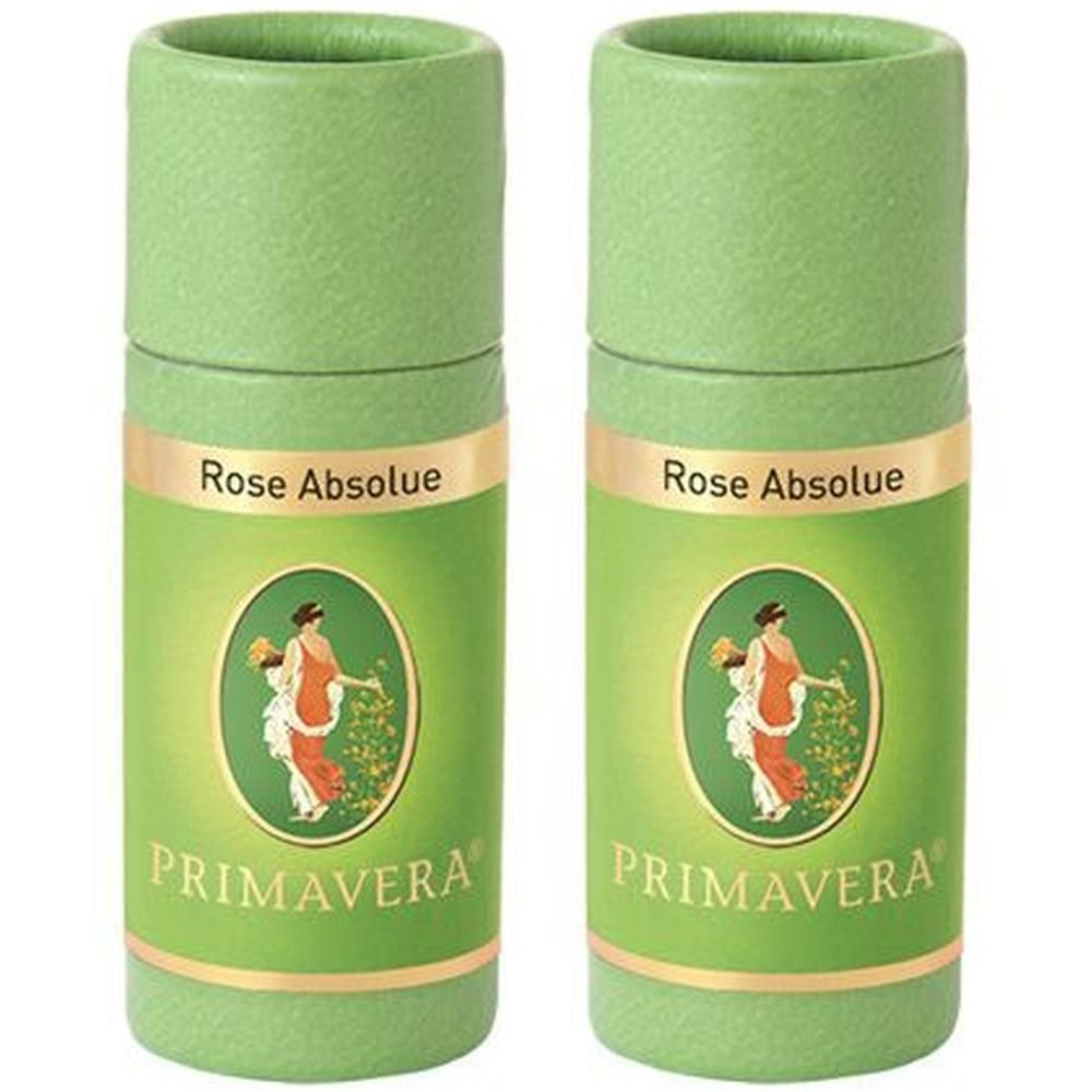 Zwei grüne zylindrische Behälter mit Etiketten. Aufschrift: Rose Absolue und PRIMAVERA. Abbildung einer Frau.