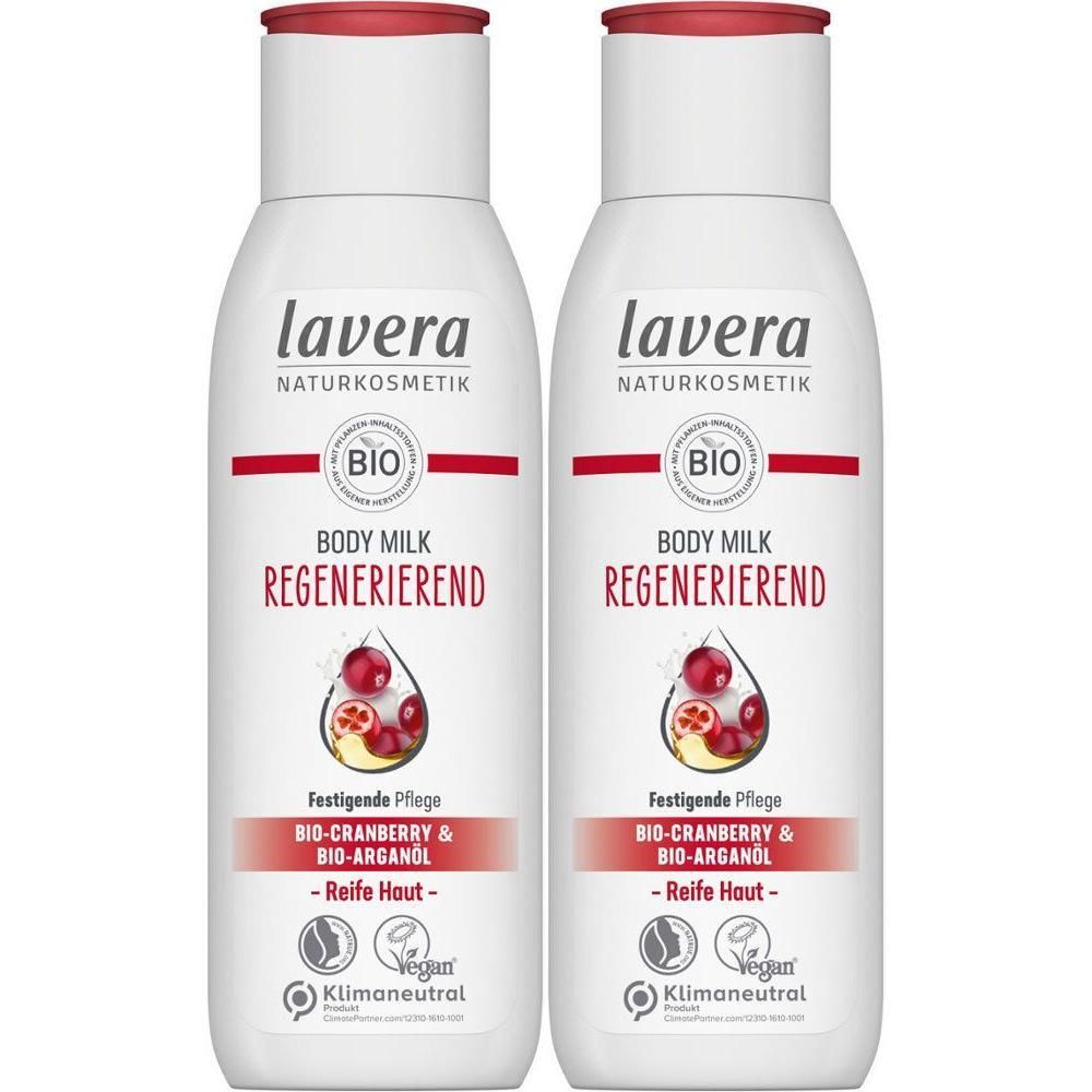 Zwei weiße Flaschen mit rotem Deckel. Aufschrift: lavera, Body Milk Regenerierend. Bio-Siegel. Cranberry- und Arganöl.