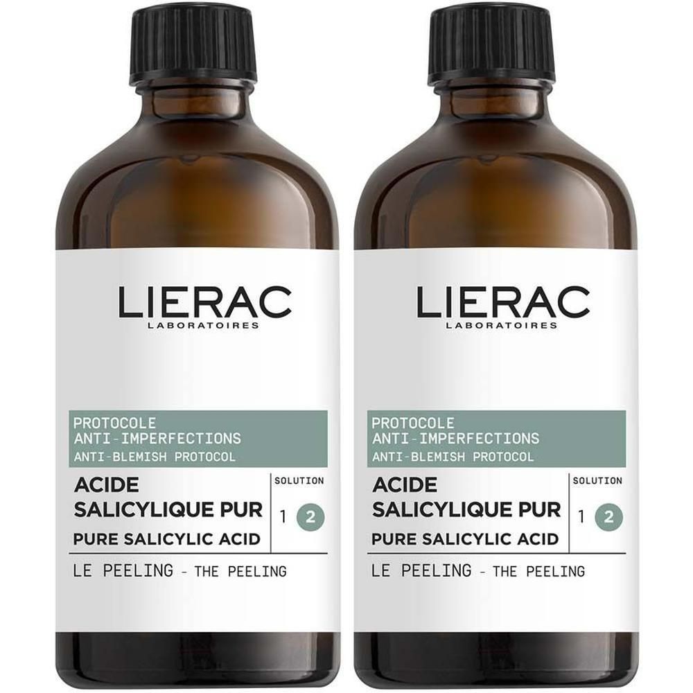 Zwei braune Glasflaschen mit schwarzem Deckel. Etikett mit Produktnamen und Text: PROTOCOLE ANTI-IMPERFECTIONS, ACIDE SALICYLIQUE PUR, LIERAC.