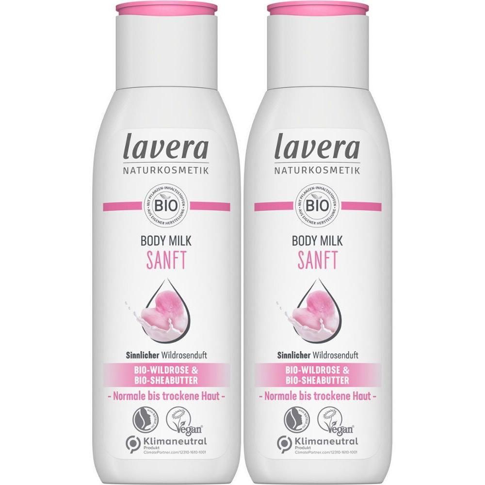 Zwei weiße Flaschen Body Milk mit rosa Deckel. Aufschrift: lavera, Body Milk sanft, Bio-Wildrose & Bio-Sheabutter. Vegan-Siegel.