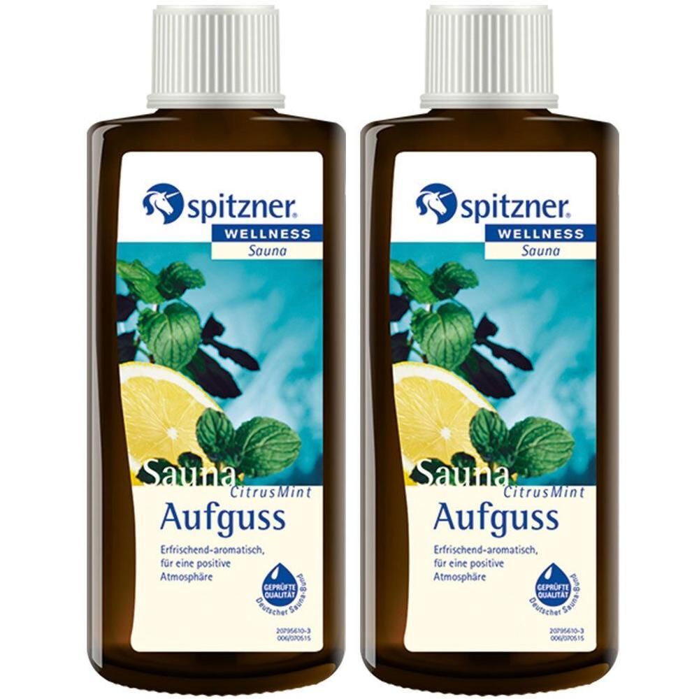 Zwei braune Flaschen mit weißem Deckel. Auf dem Etikett: Logo, Schriftzug „Wellness Sauna“, Abbildung von Zitrone und Minze. Aufguss.