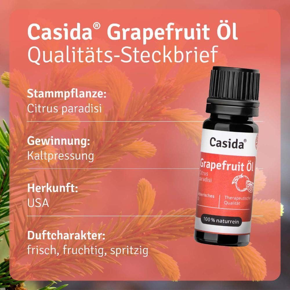 Flasche Casida® Grapefruit Öl. Schwarze Kappe, weißes Etikett mit rotem Band. Text: Grapefruit Öl, Citrus paradisi, therapeutische Qualität. Hintergrund: Pflanzen.