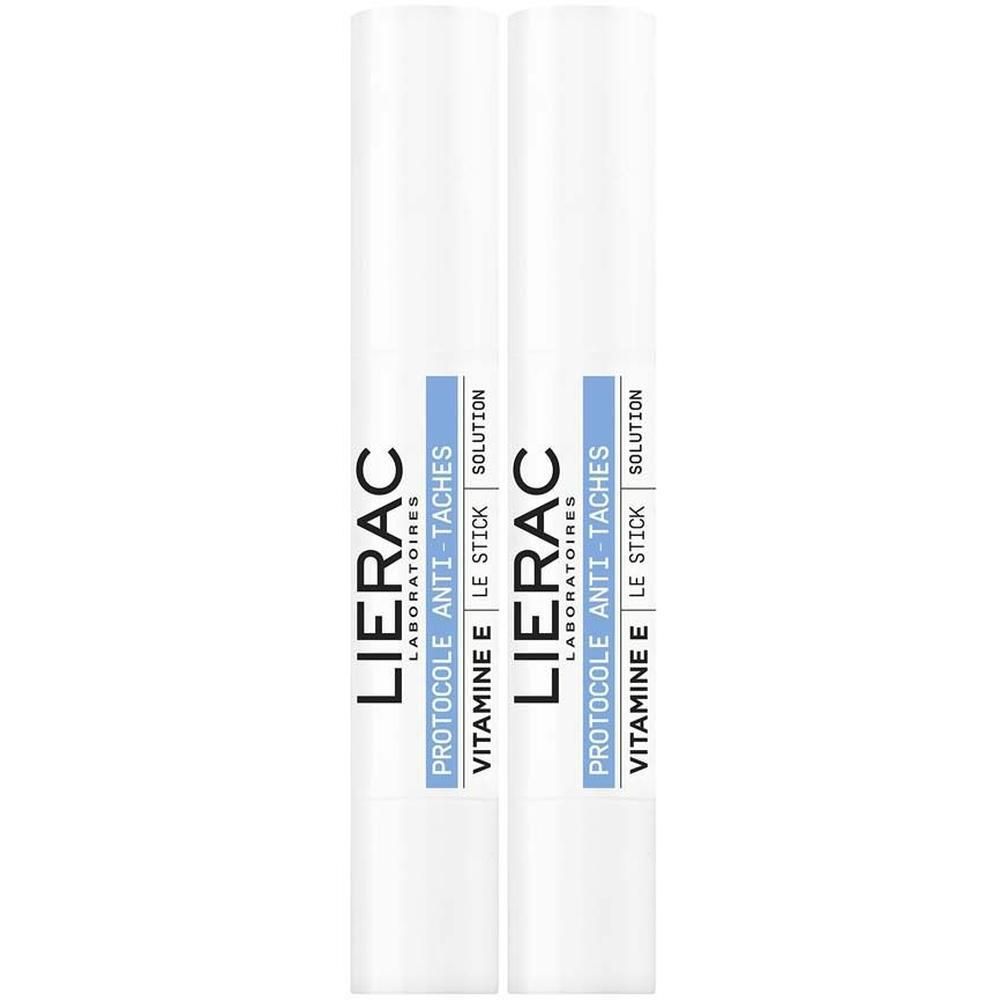 Zwei weiße Stifte mit blauen Streifen und Text. Aufschrift: LIERAC, Protocole Anti-Taches, Vitamine E, Le Stick, Solution.