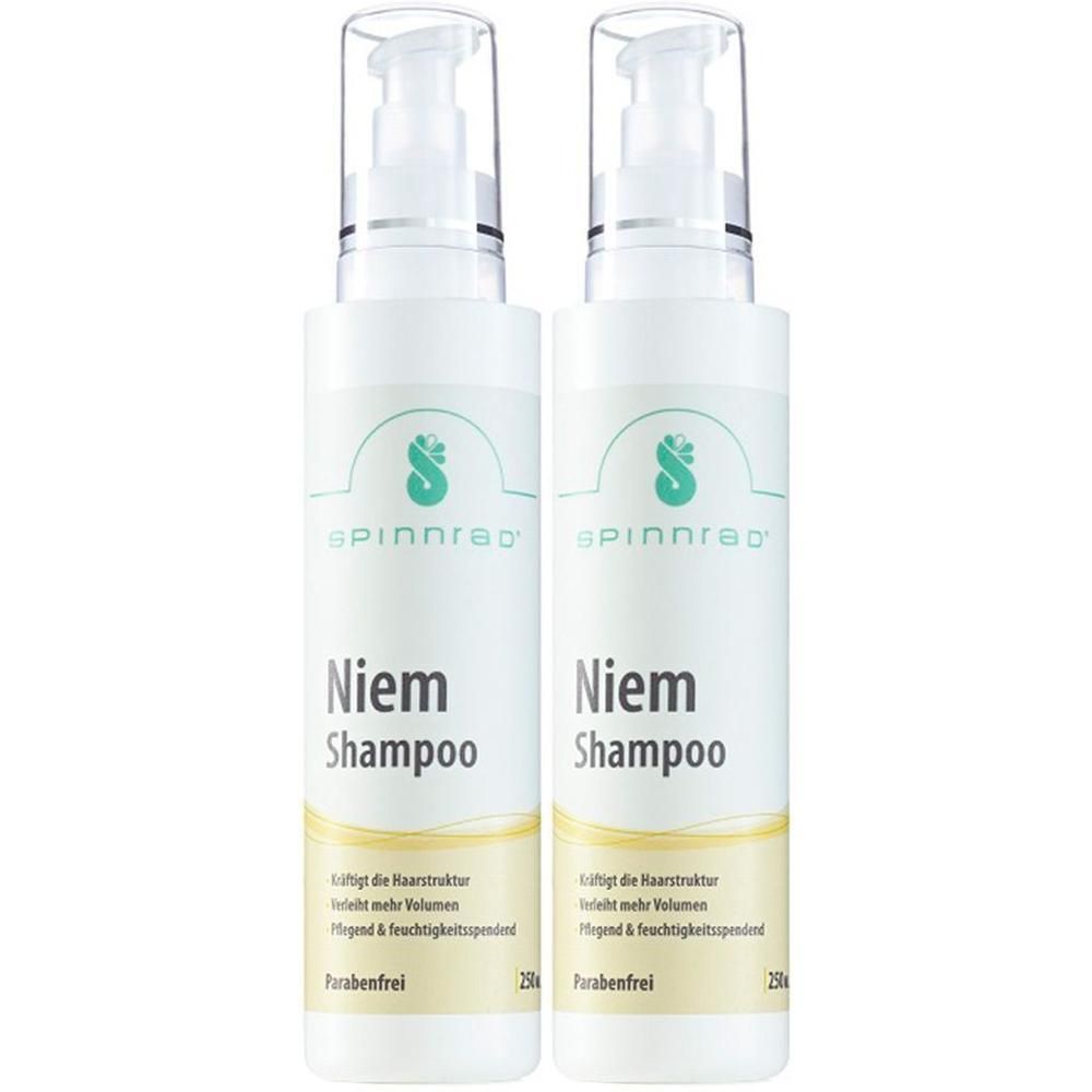 Zwei weiße Flaschen mit Spinnrad Niem Shampoo. Jede Flasche hat einen Pumpkopf und gelbe Akzente. Aufgedruckt: Niem Shampoo, Parabenfrei.
