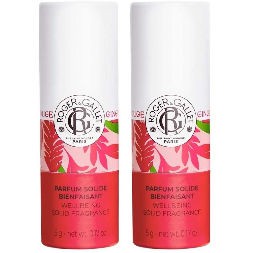 Zwei zylindrische Parfumsticks. Weißer Deckel, roter Boden mit floralem Muster. Text: PARFUM SOLIDE BIENFAISANT, WELLBEING SOLID FRAGRANCE.