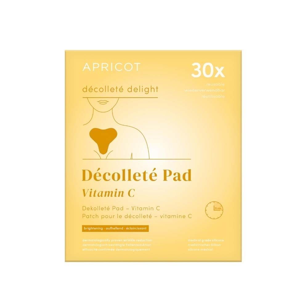 Gelber Karton mit Aufdruck: APRICOT, Décolleté Pad Vitamin C. Abbildung eines Dekolletés.