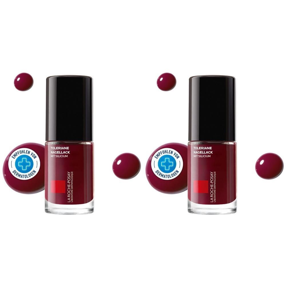 Zwei Flakons Nagellack, dunkelrot, mit schwarzem Deckel. Aufschrift: La Roche-Posay, Toleriane. Runde, rote Farbkleckse und ein Siegel.