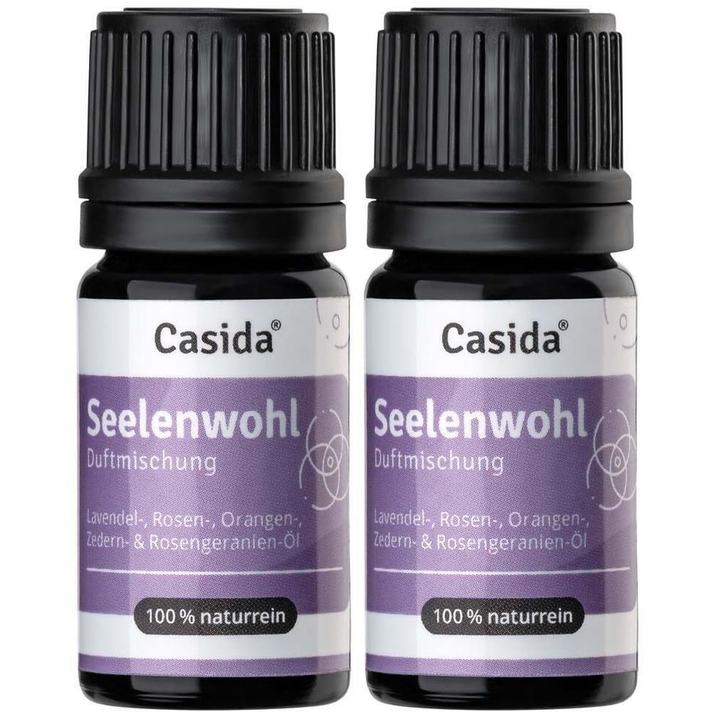 Zwei Flaschen Casida® Seelenwohl Duftmischung. Schwarze Deckel, violette Etiketten. Text: 100% naturrein.