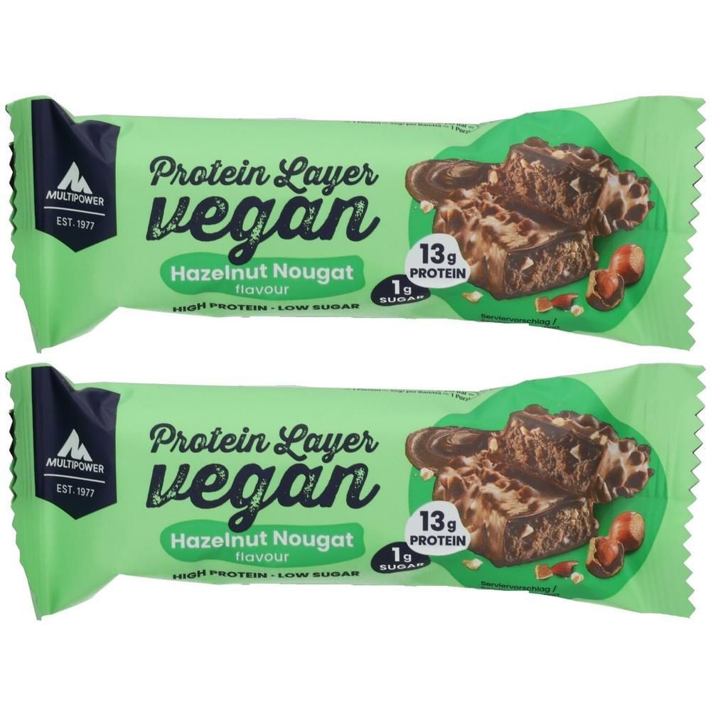 Zwei Proteinriegel in grüner Verpackung. Aufschrift: Protein Layer vegan, Haselnuss Nougat. Enthält 13g Protein und 1g Zucker. Marke: Multipower.