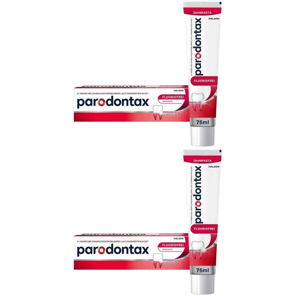 Zwei Tuben und zwei Schachteln Zahnpasta. Aufschrift: parodontax, fluoridfrei. Rote und weiße Verpackung.