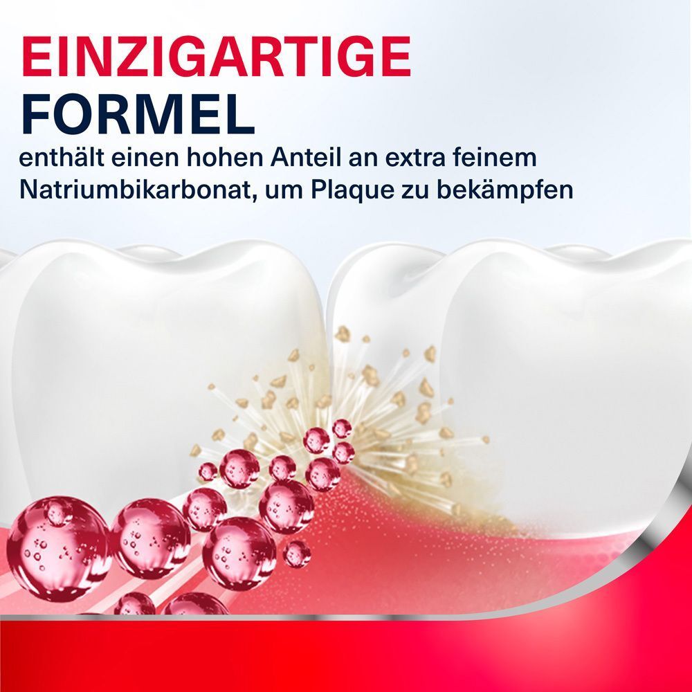 Zwei Zähne und rote Kügelchen. Text: Einzigartige Formel. Enthält Natriumbikarbonat, um Plaque zu bekämpfen.