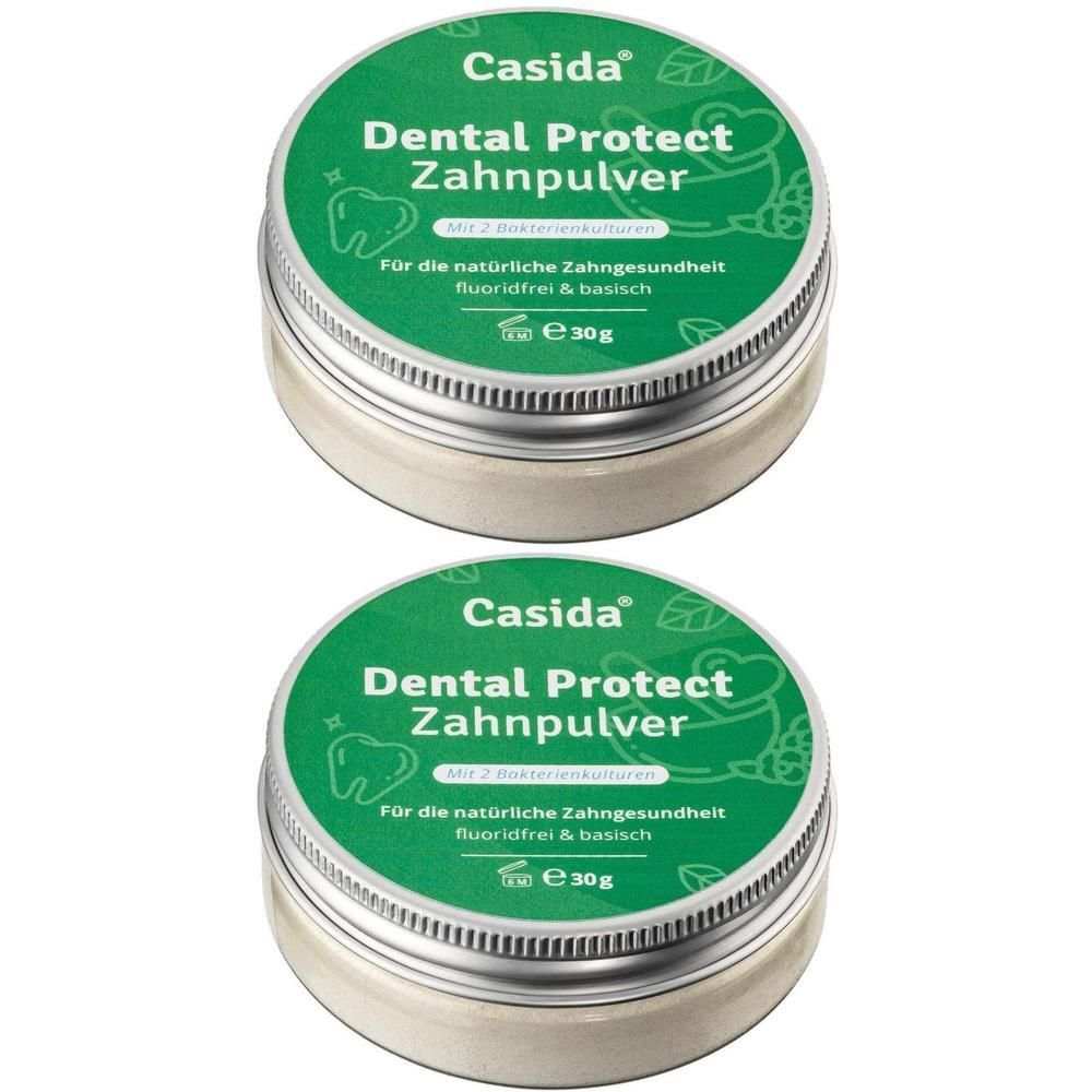 Zwei runde Dosen Casida Dental Protect Zahnpulver. Grüne Deckel mit weißer Schrift. Metallbehälter.