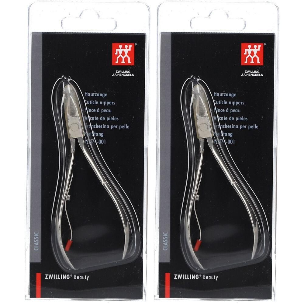Zwei Hautzangen in Blisterverpackung. Metallfarbene Zangen mit roter Spitze. Schwarze Verpackung mit weißer Schrift und Logo.