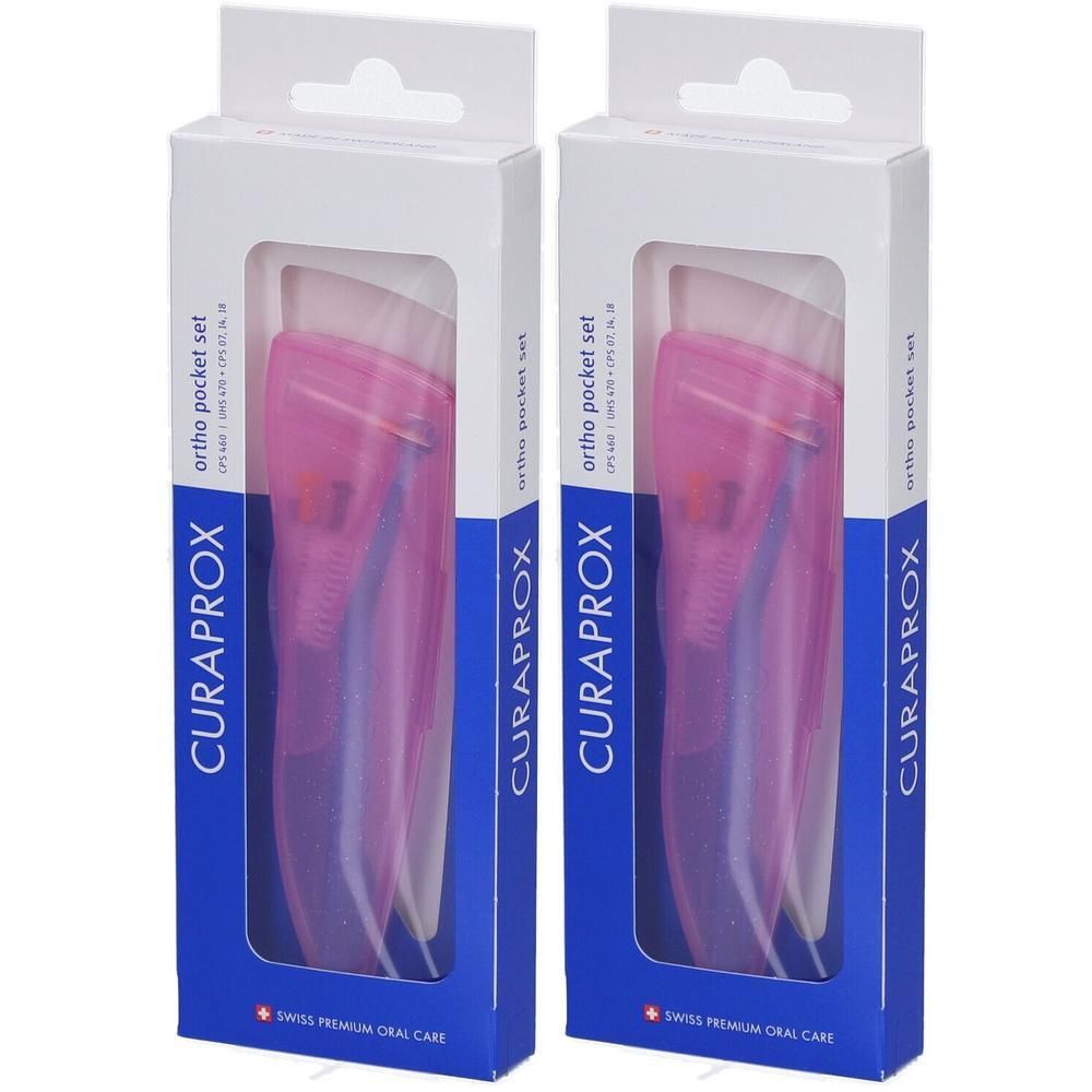 Zwei Packungen Curaprox® CPS 460 pocket Set. Weiße Kartons mit Sichtfenster. Rosa Bürsten in transparenten Hüllen. Blaue Elemente sichtbar.