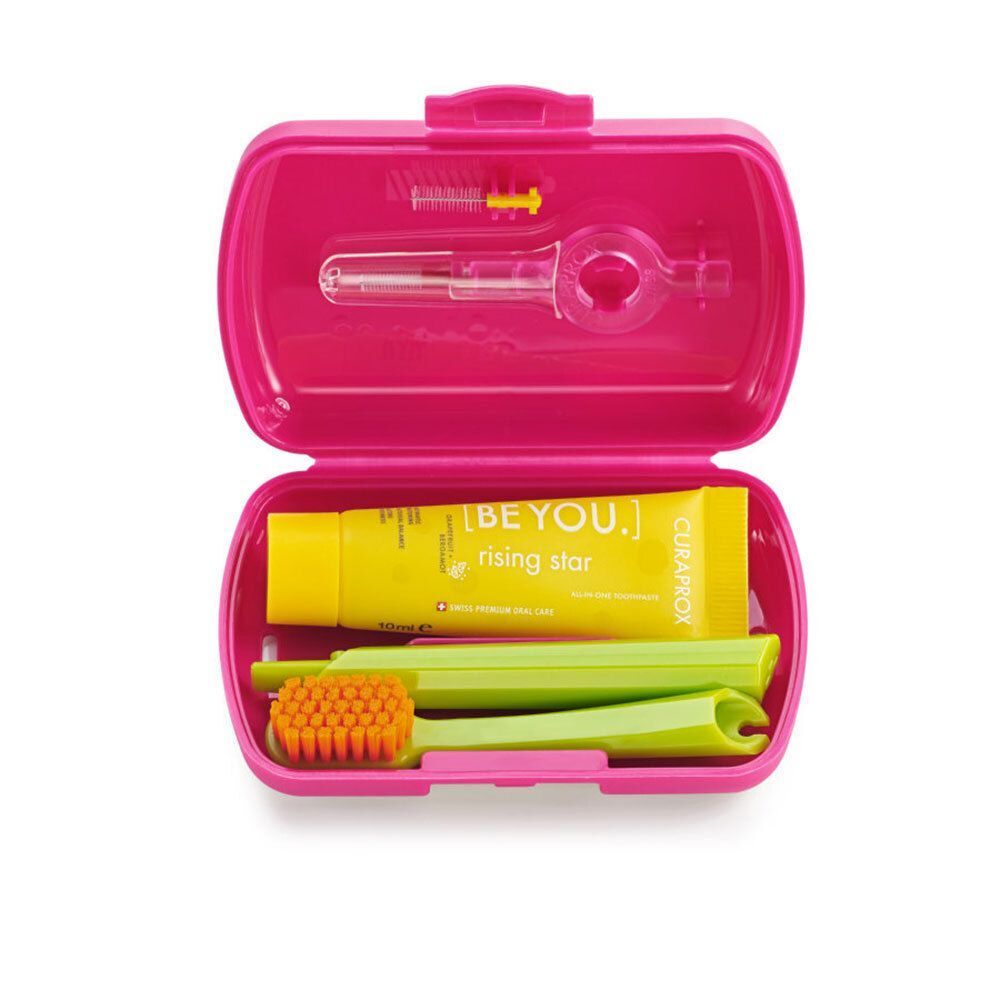 Offenes rotes Reise-Set mit Zahnbürste, Zahnpasta, Interdentalbürsten und Halterung. Die Zahnpasta trägt den Schriftzug "BE YOU".
