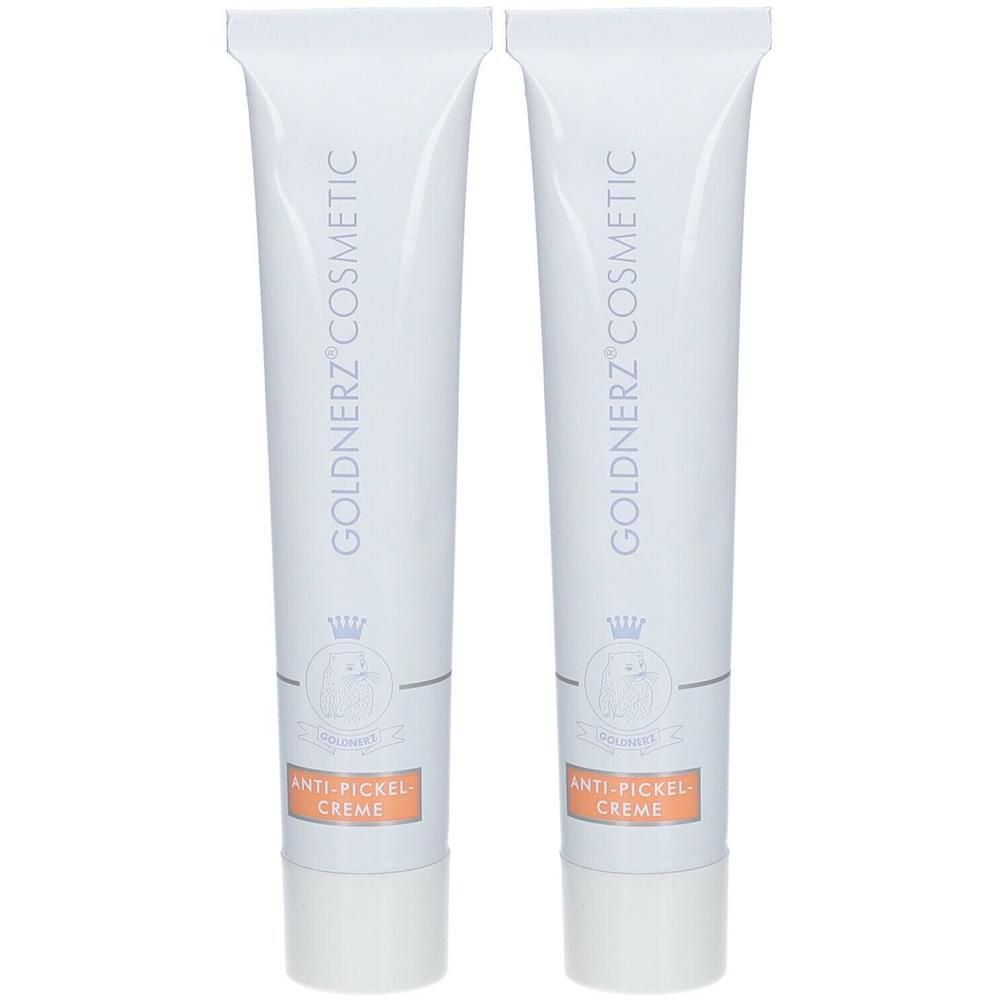 Zwei weiße Tuben GOLDNERZ COSMETIC Anti-Pickel-Creme. Aufschrift: GOLDNERZ COSMETIC, Logo, Anti-Pickel-Creme.