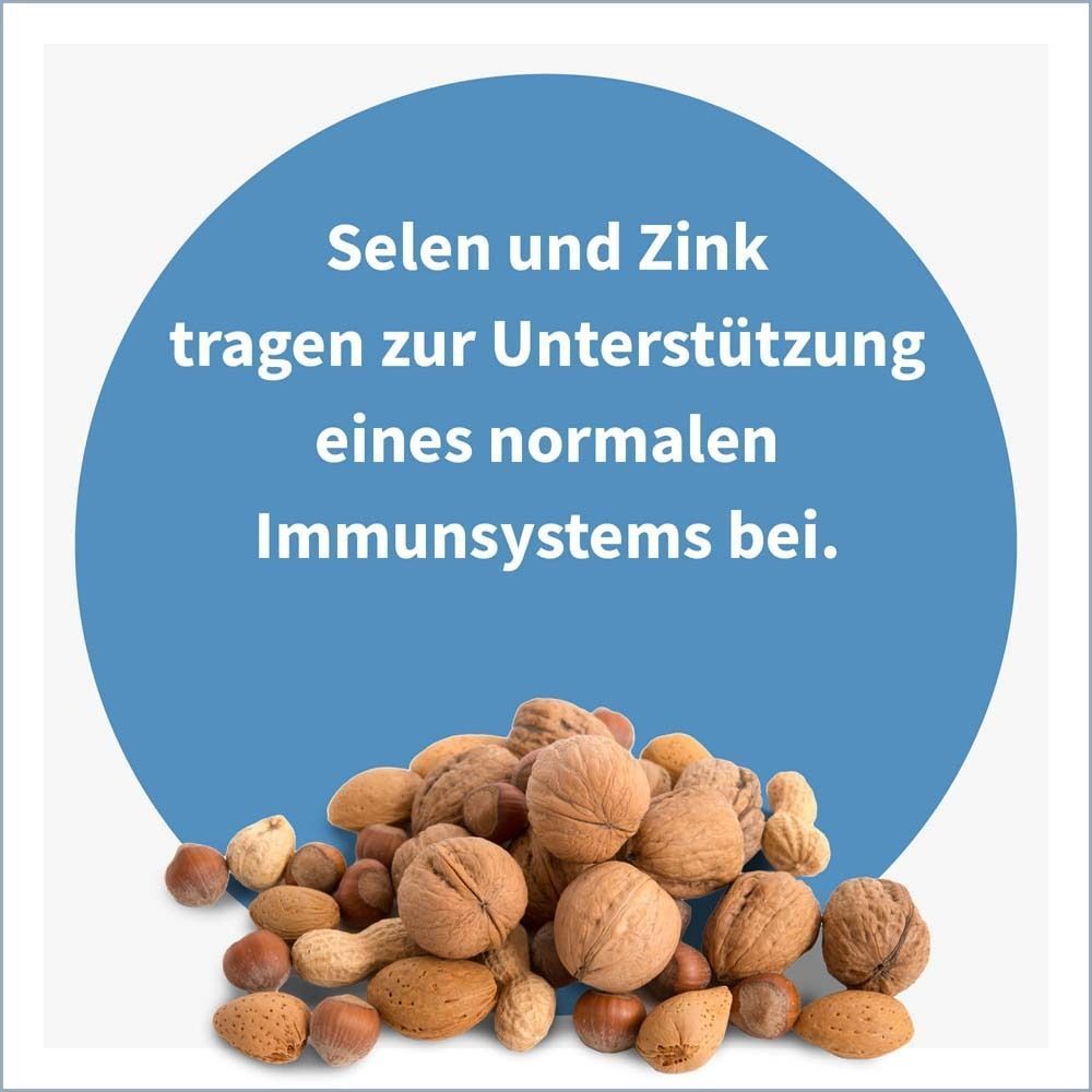 Blauer Kreis mit Text: Selen und Zink tragen zur Unterstützung eines normalen Immunsystems bei. Nüsse und Samen darunter.