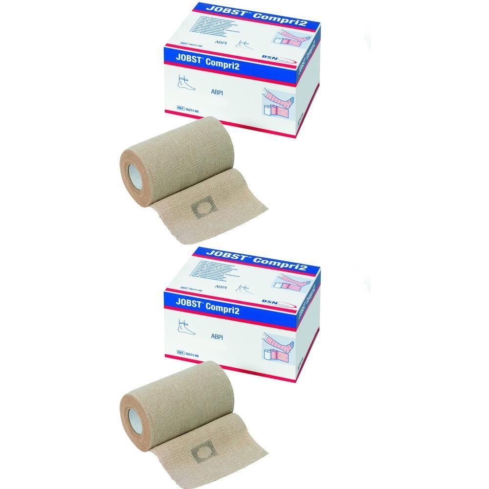 Zwei Rollen Kompressionsbinden und zwei Produktverpackungen. Aufschrift: JOBST Compri2. Beige Binden, weiß-blaue Verpackung.