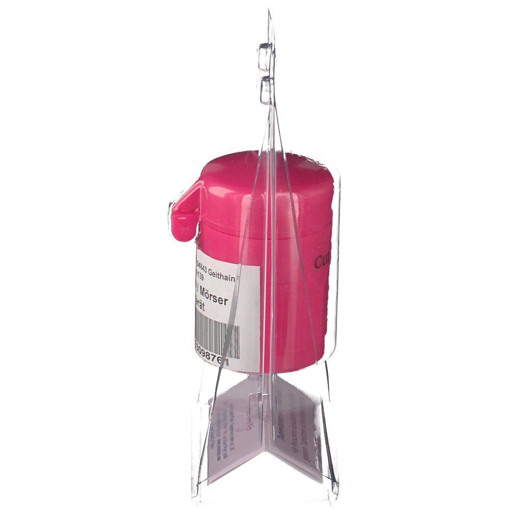 Pinkfarbener Tablettenteiler/Mörser in transparenter Verpackung. Seitliche Ansicht. Mit CE-Kennzeichnung.