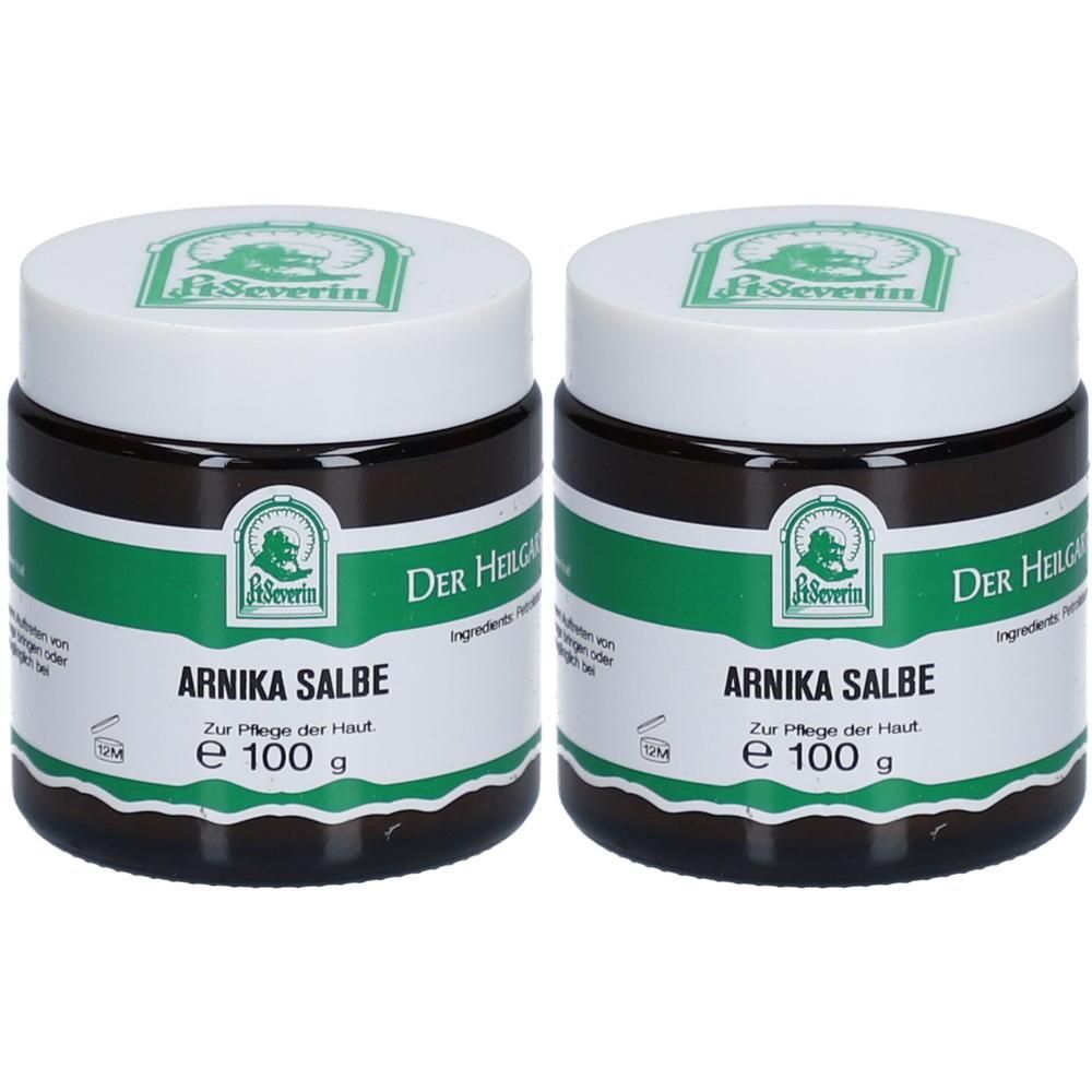 Zwei Tiegel Arnika Salbe mit weißem Deckel und grünem Etikett. Aufschrift: Arnika Salbe, e 100 g. Marke: St. Severin.