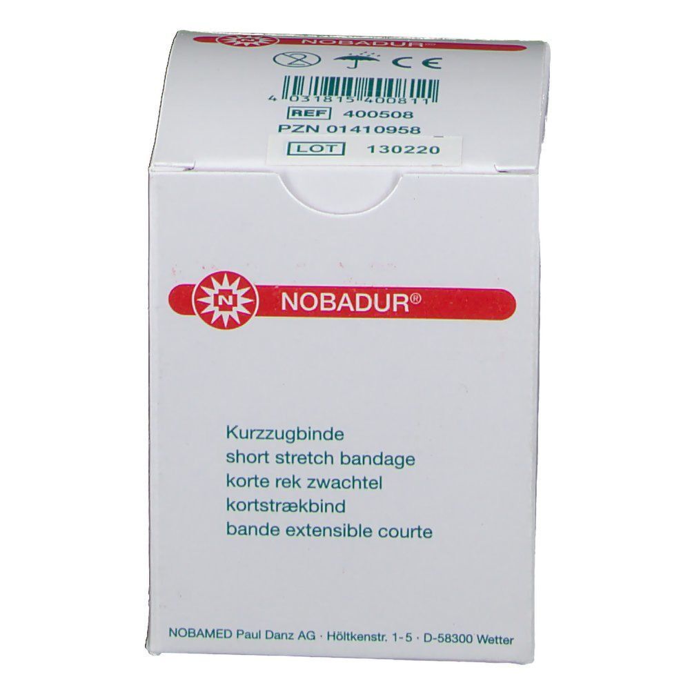 Weiße Verpackung mit rotem Logo und Produktinformationen. Text: NOBADUR®, Kurzzugbinde, short stretch bandage, korte rek zwachtel, kortstrækbind, bande extensible courte.