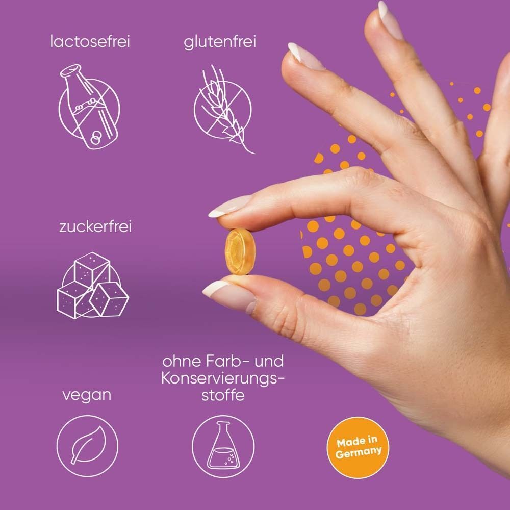 Hand hält eine ipalat® Vitaminpastille. Symbole für lactosefrei, glutenfrei, zuckerfrei, vegan.