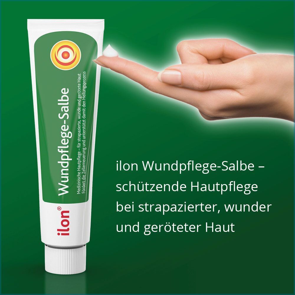 Tube "ilon Wundpflege-Salbe" mit Finger, der Salbe entnimmt. Grün-weiße Farbgebung.