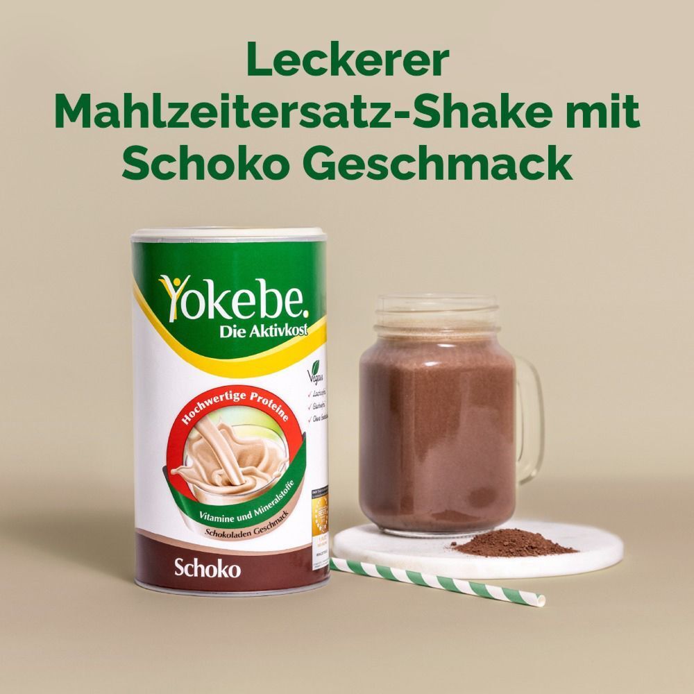 Yokebe Shakepulver Schoko Dose neben einem Glas Shake und Pulver auf einem Teller. Text: Mahlzeitersatz-Shake.