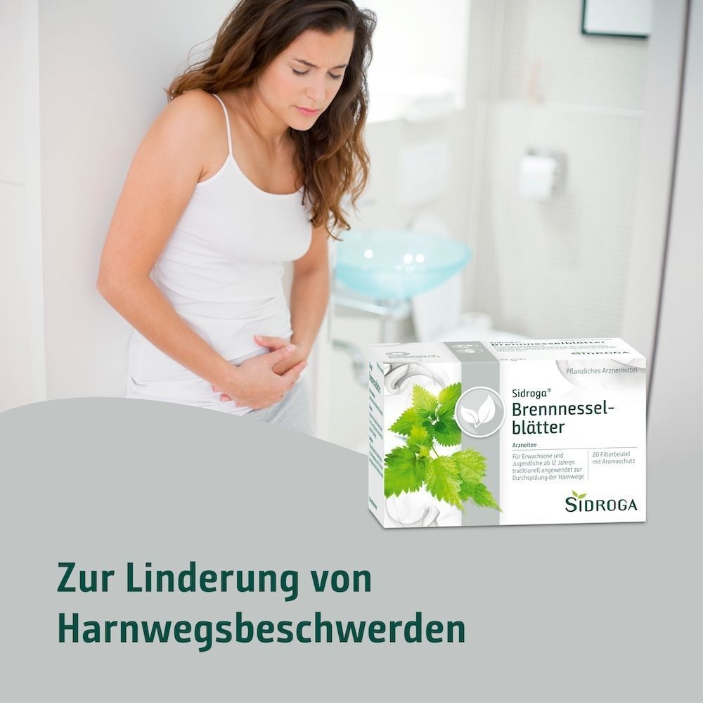 Frau mit Bauchschmerzen neben einer Packung Sidroga Brennesselblättertee.
