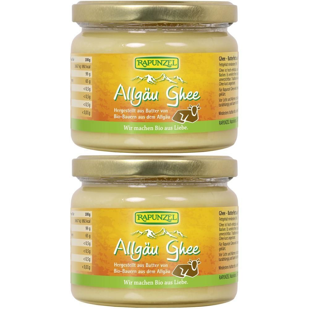 Zwei Gläser mit goldfarbenem Inhalt und goldenen Deckeln. Auf den Etiketten steht "RAPUNZEL Allgäu Ghee".