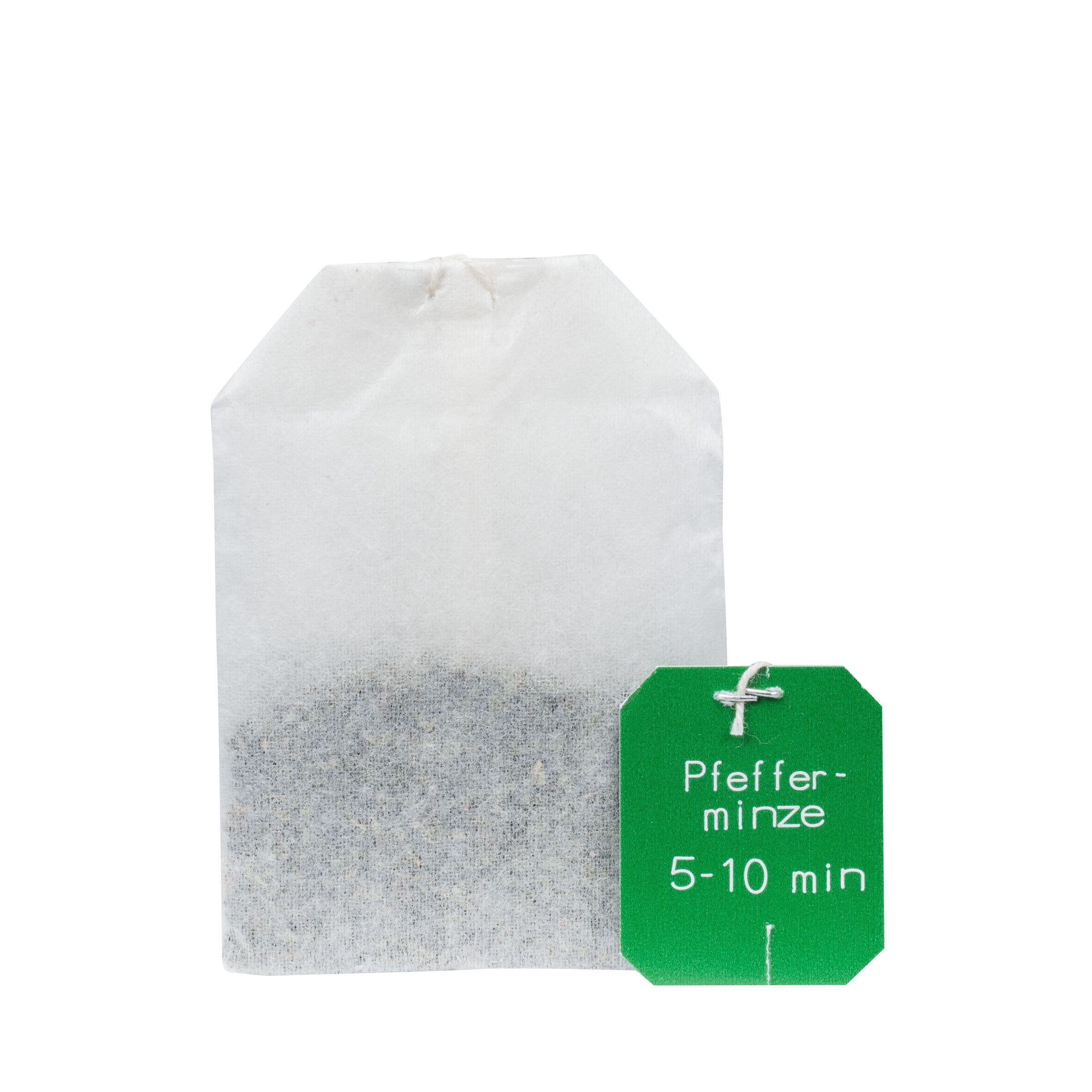Einzelner Teebeutel und grünes Etikett mit Text: Pfefferminze, 5-10 min.