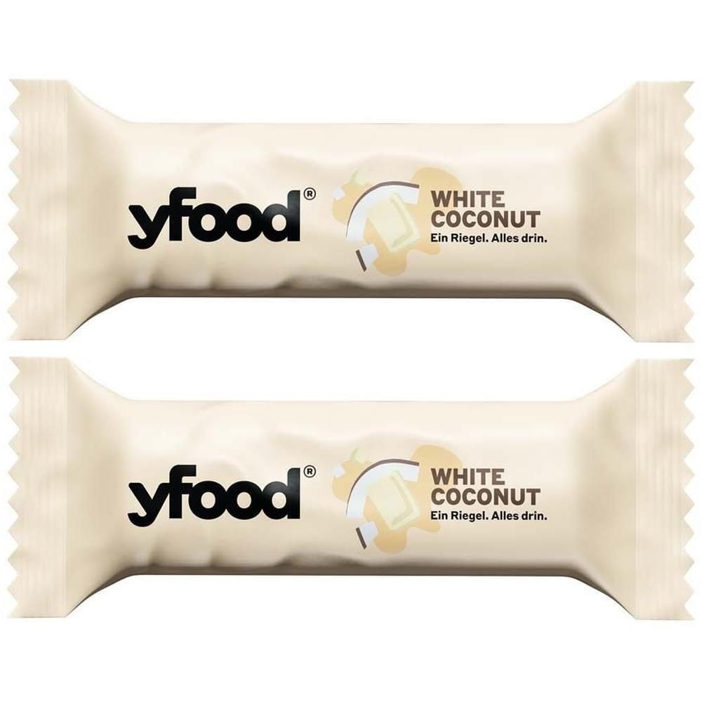Zwei Riegel in weißer Verpackung. Aufdruck: yfood, White Coconut. Text: Ein Riegel. Alles drin.