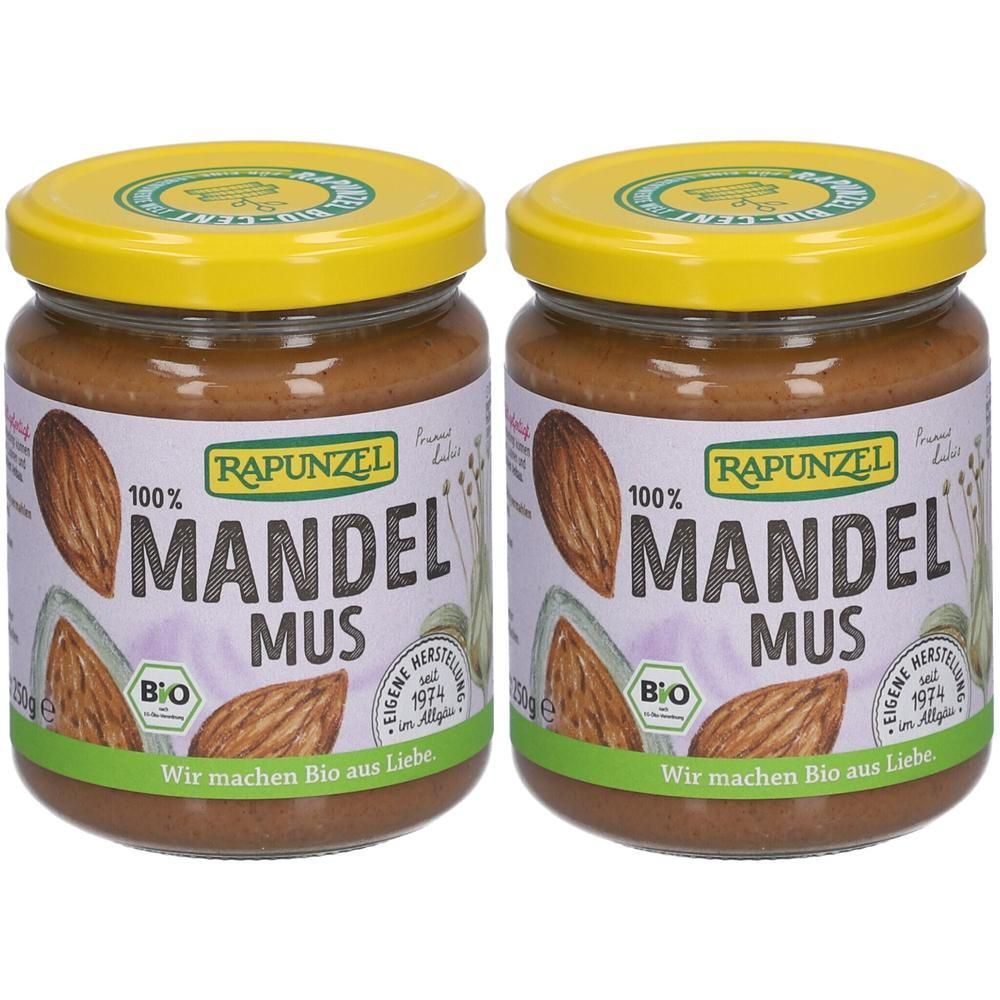 Zwei Gläser Mandelmus mit gelben Deckeln. Auf den Etiketten steht "Rapunzel Mandel Mus" und "Bio".