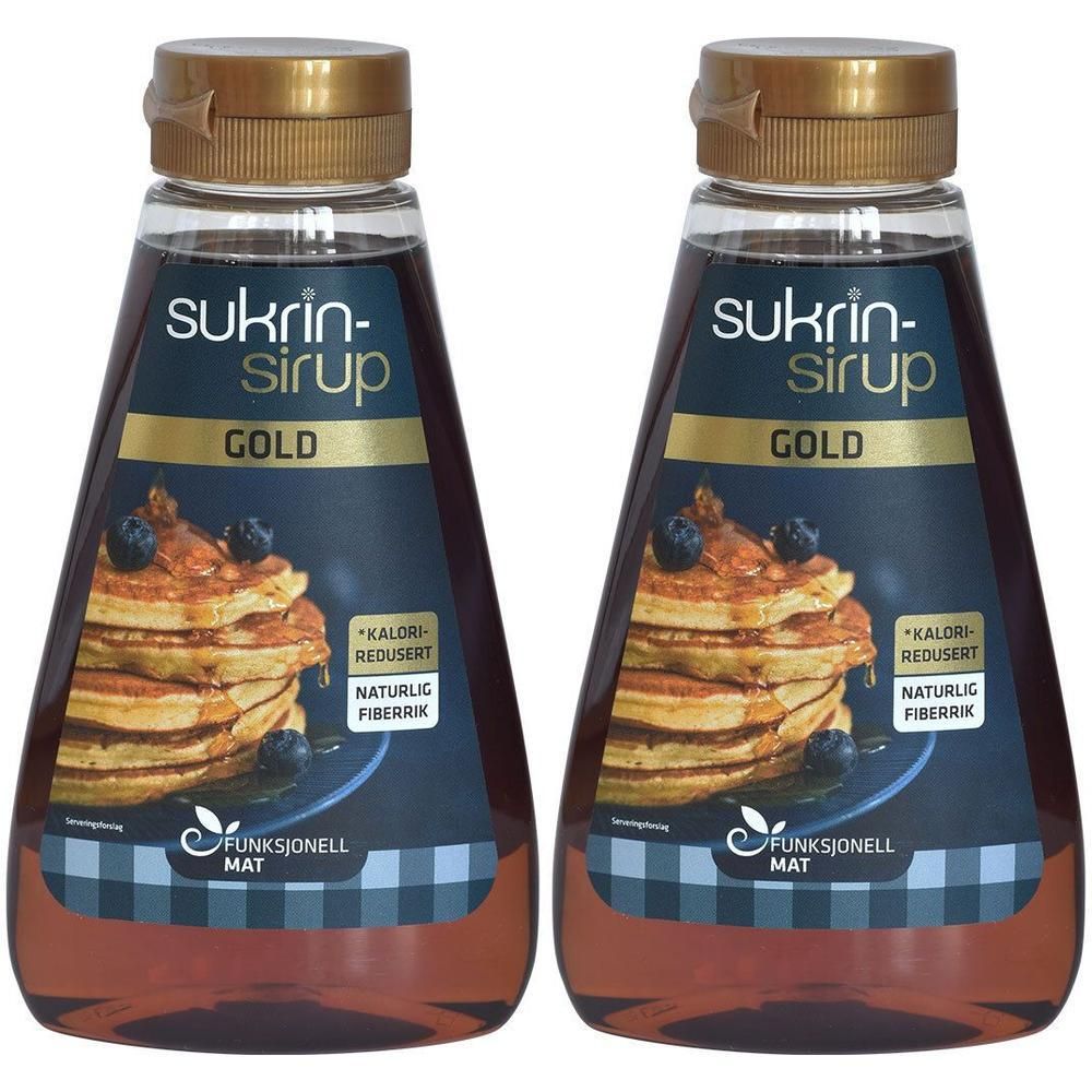 Zwei Flaschen Sirup. Aufschrift: Sukrin-Sirup Gold. Abbildung von Pfannkuchen mit Blaubeeren. Goldfarbener Deckel.