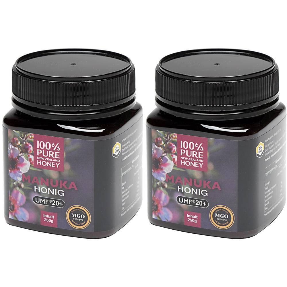 Zwei Gläser Honig mit schwarzem Deckel. Aufschrift: 100% Pure Honey, Manuka Honig UMF 20+, MGO. Inhalt 250g.
