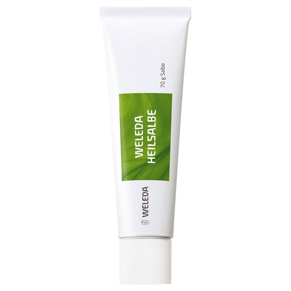 Eine weiße Tube mit grünem Etikett. Auf dem Etikett steht "WELEDA HEILSALBE". Am unteren Ende der Tube steht "70 g Salbe".