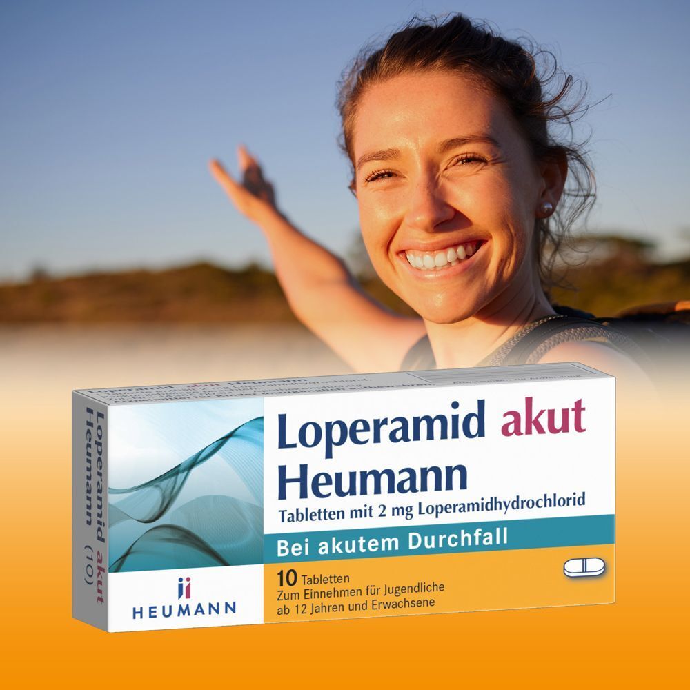 Loperamid akut Heumann Tabletten (10 Stück) vor einer lächelnden Frau im Freien.