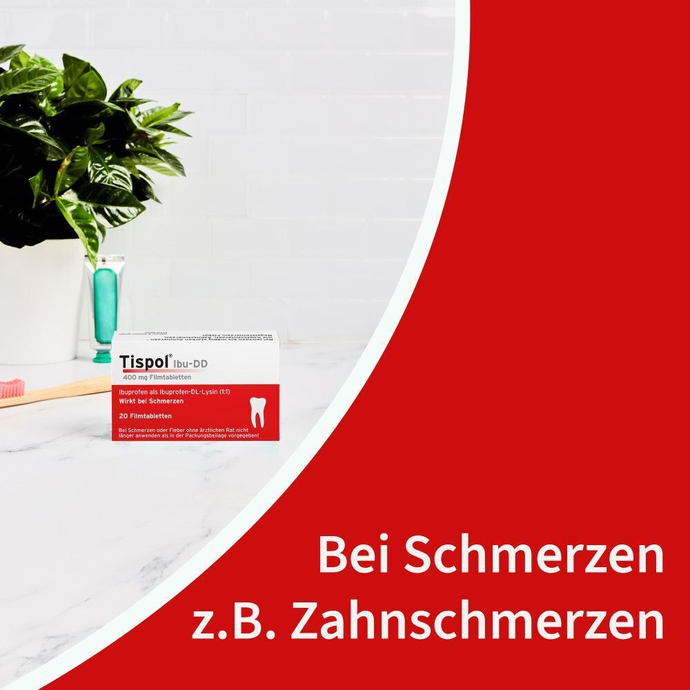 Packung Tispols Ibu-DD auf einem Tisch neben einer Pflanze und Zahnbürste.