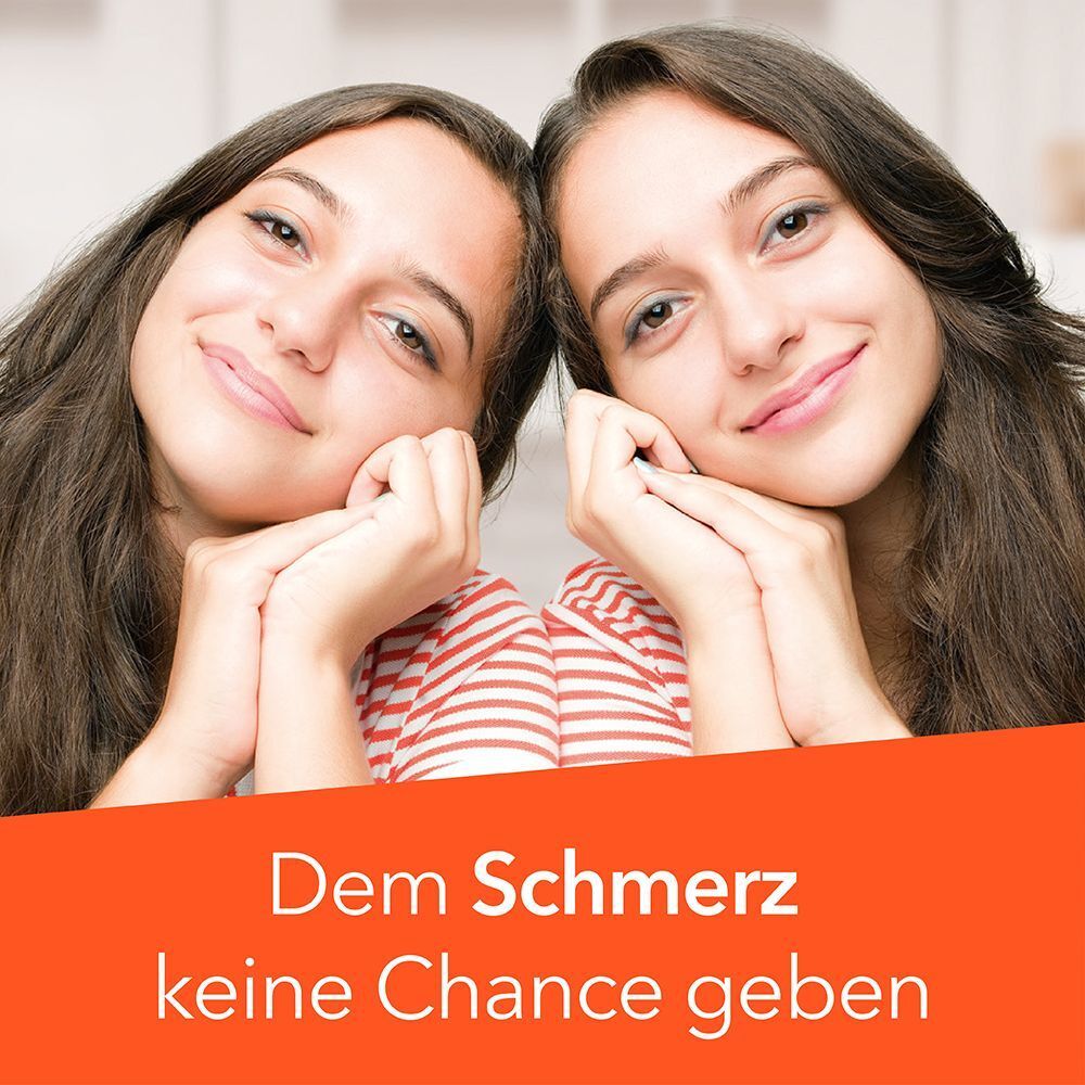 Zwei lächelnde junge Frauen mit den Händen am Kinn.