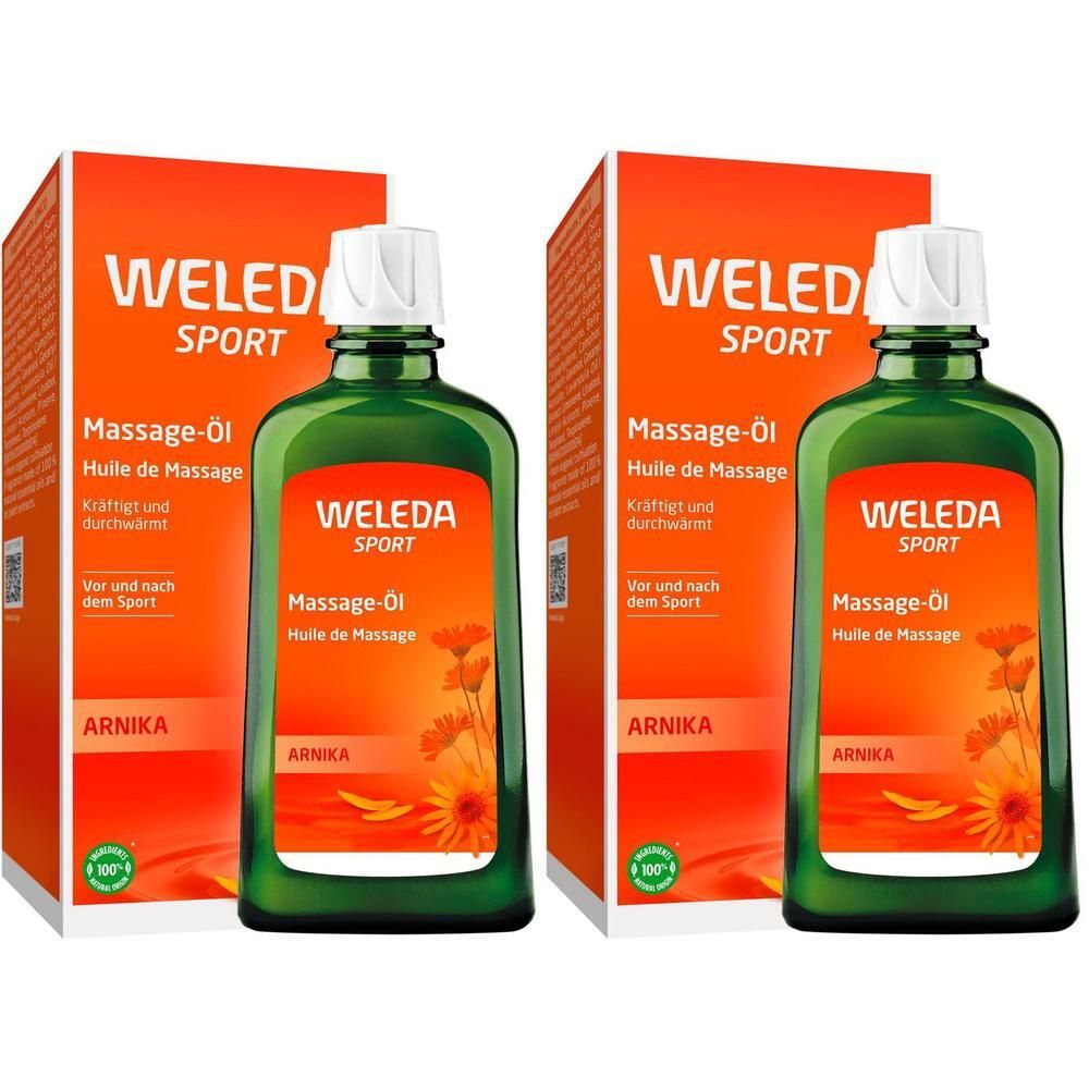 Zwei Flaschen Weleda Arnika Massageöl neben ihren Kartons.