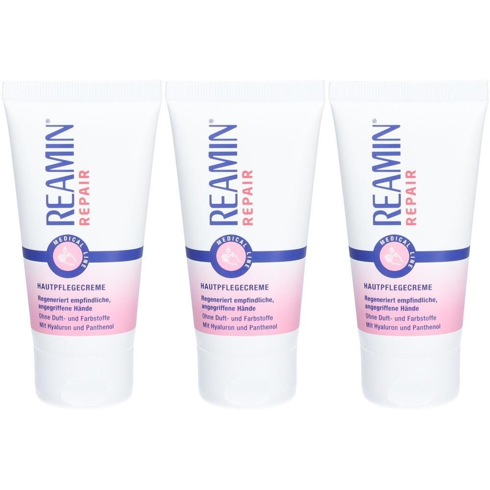 Drei Tuben REAMIN® REPAIR Hautpflegecreme, weiß mit blauen und rosa Etiketten.