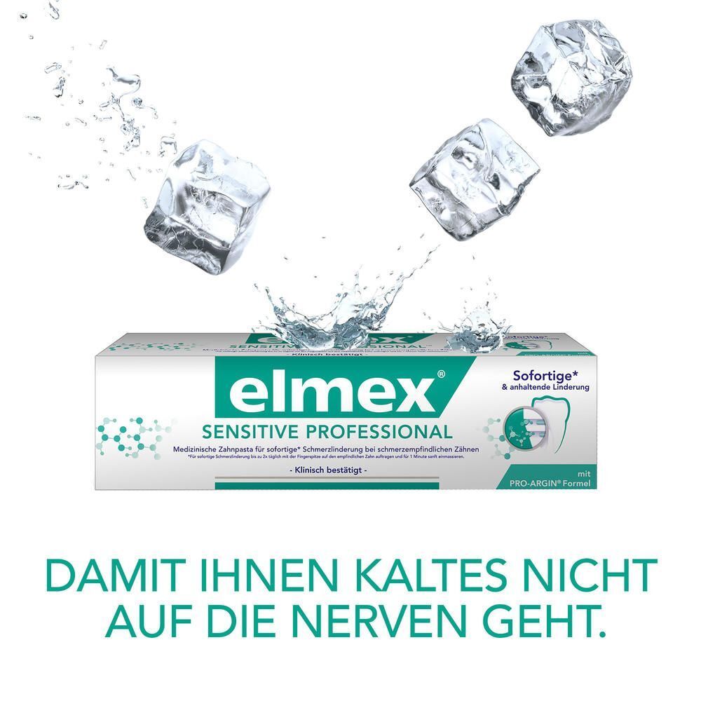 Zahnarzt in türkisfarbener Kleidung mit verschränkten Armen.