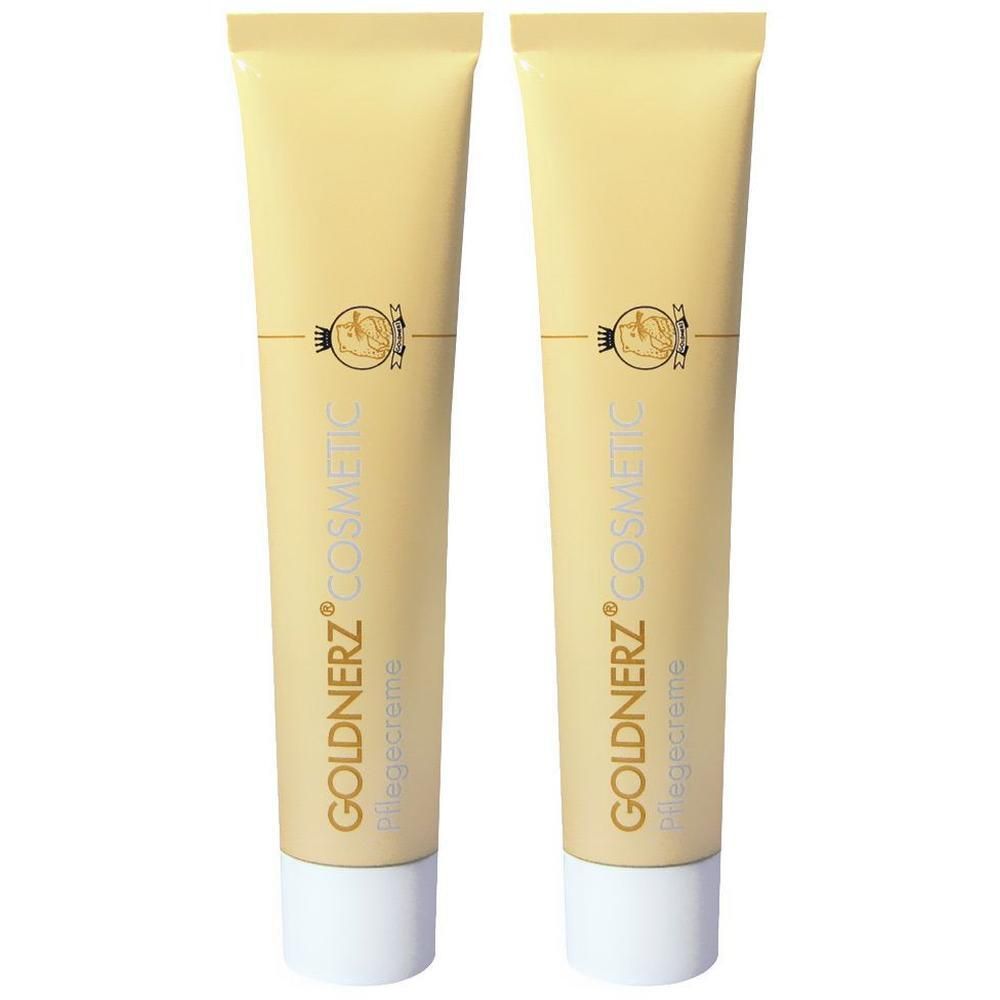 Zwei goldene Tuben GOLDNERZ® Pflegecreme mit weißem Verschluss.