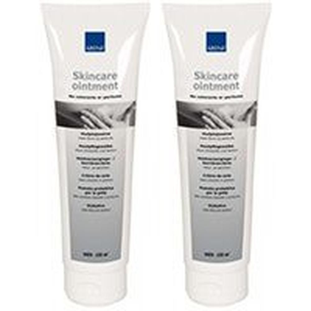Zwei Tuben Skincare Salbe mit blauem Logo und Text. Zeigt Hände, die sich berühren.