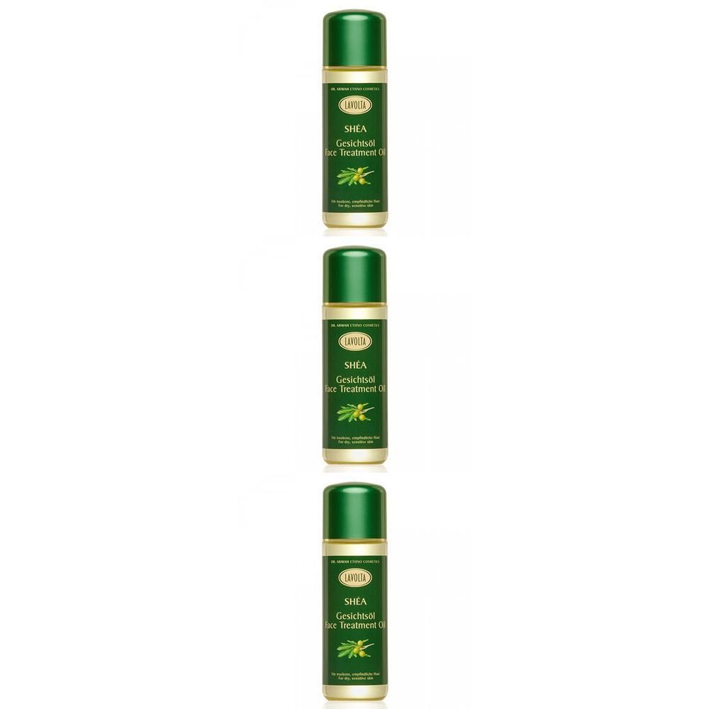Drei Flaschen LAVOLTA SHEA Gesichtsöl mit grünen Kappen und Etiketten, die Sheanüsse zeigen.