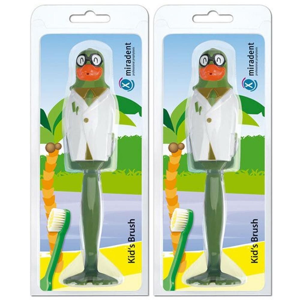 Zwei grüne Kinderzahnbürsten im Papageien-Design mit weißem Kittel, verpackt.